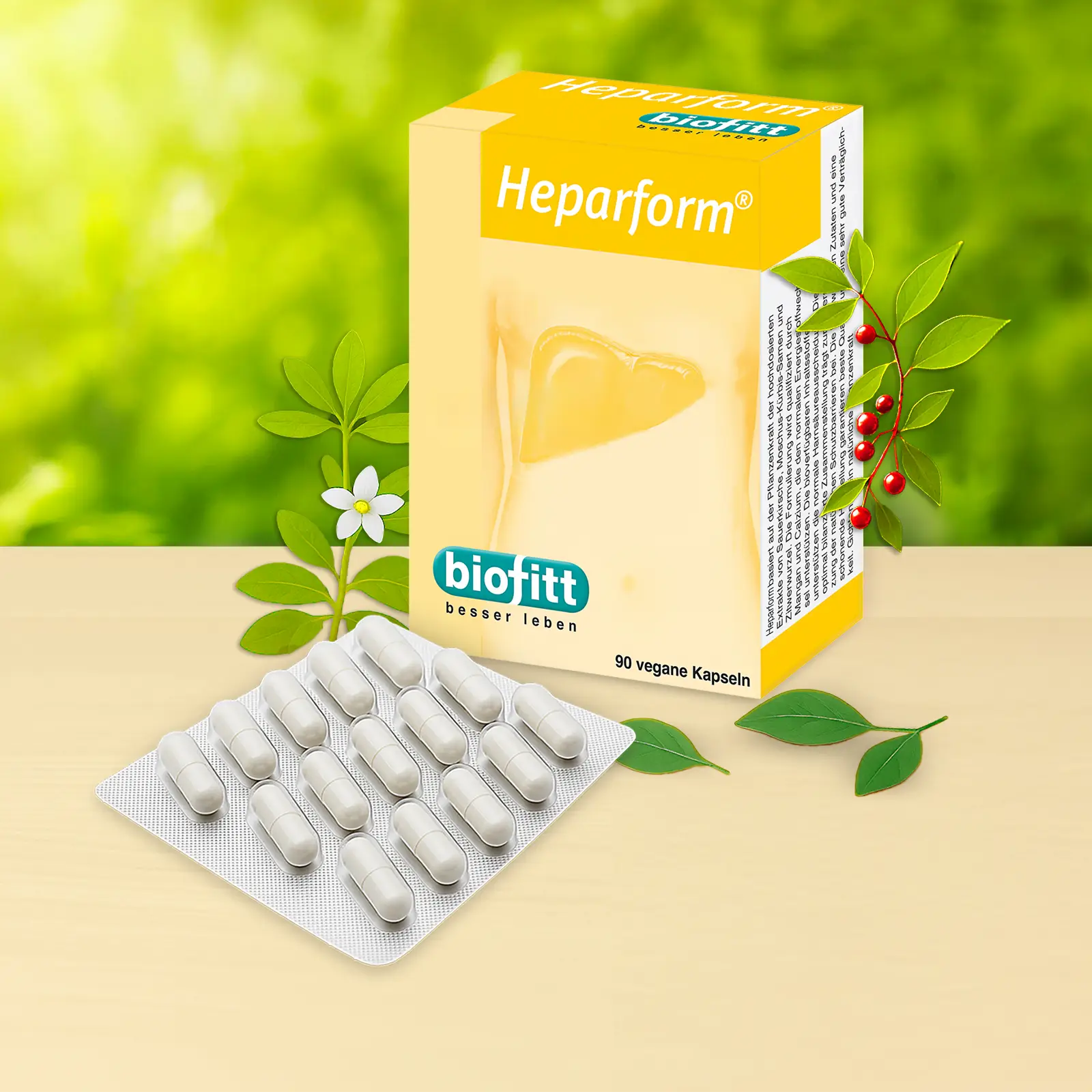 Heparform Leberkapseln von biofitt mit Faltschachtel und Blister vor grünem Pflanzenhintergrund